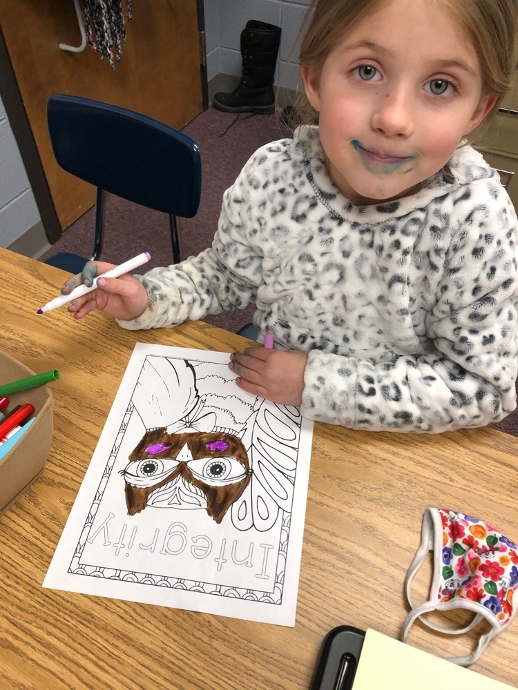 Kindergarten student working on her Integrity color sheet.